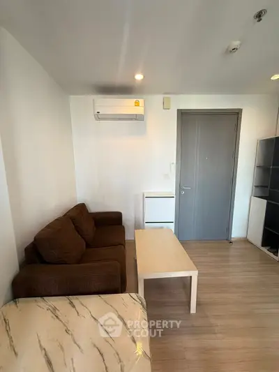Cozy living room with modern furniture and air conditioning in a stylish apartment.