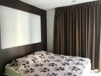 Cozy bedroom with floral bedding and elegant curtains