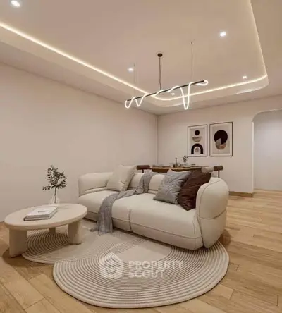 Modern living room with stylish lighting and cozy seating area, perfect for relaxation and entertaining.