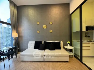 Modern living room with stylish decor and adjacent kitchen in a high-rise apartment