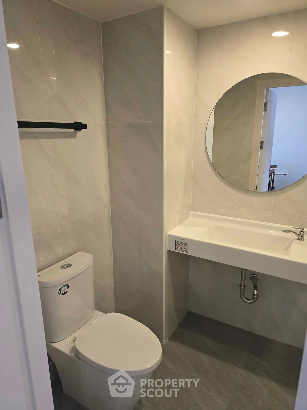 Modern bathroom with sleek design and round mirror