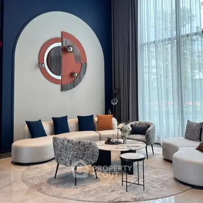 Modern living room with stylish decor and large windows