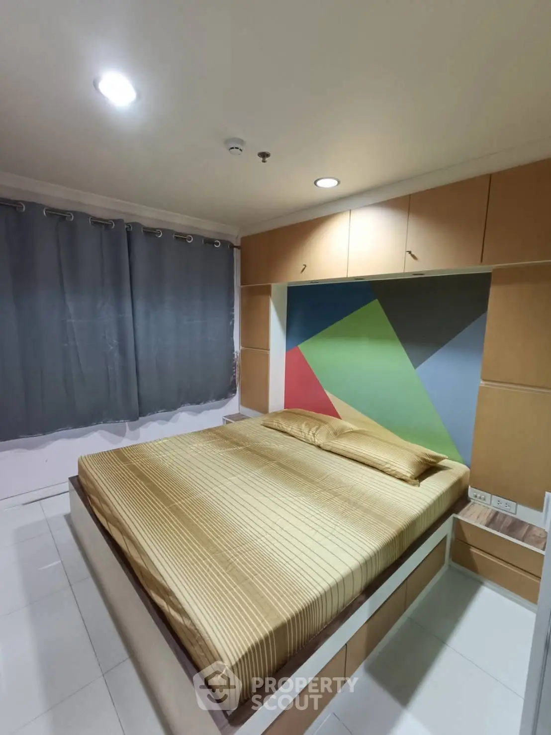 Modern bedroom with colorful accent wall and built-in storage