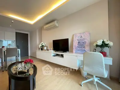 Modern living room with stylish decor, TV, and air conditioning in a cozy apartment.