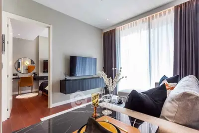 Modern living room with stylish decor and natural light in a contemporary apartment.