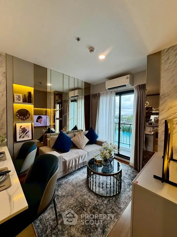 Modern living room with elegant decor and pool view from balcony.