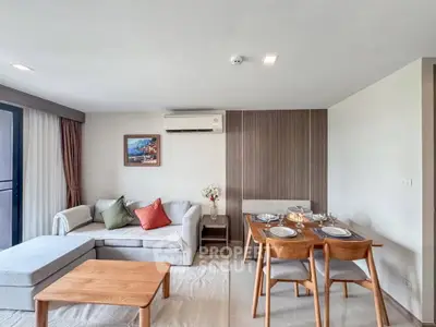 Modern living room with cozy sofa and dining area in stylish apartment