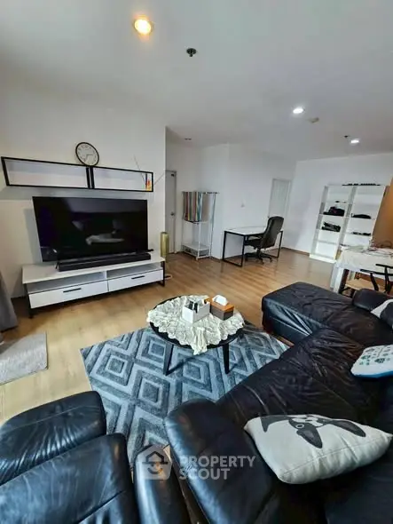 Spacious living room with modern decor and large TV setup