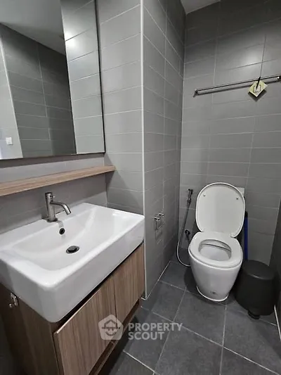 Modern bathroom with sleek gray tiles and contemporary fixtures