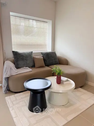 Stylish living room with modern furniture and cozy decor, perfect for relaxation.