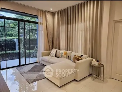 Elegant living room with large windows and cozy sectional sofa