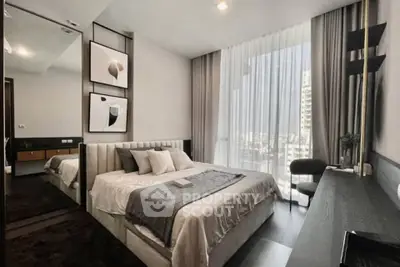 Luxurious modern bedroom with floor-to-ceiling windows and elegant decor in a high-rise apartment.