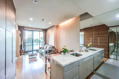 Modern open-layout living room with sleek kitchen and balcony view