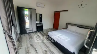 Spacious modern bedroom with stylish decor and ample natural light