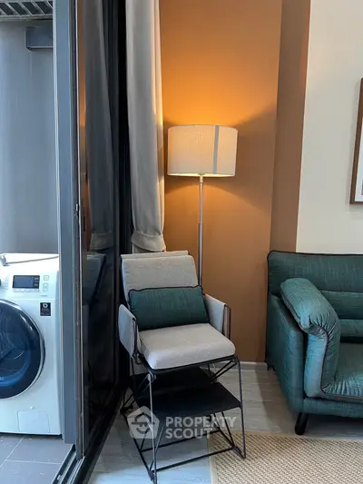 Modern living room with stylish furniture and washing machine in a cozy corner setup.