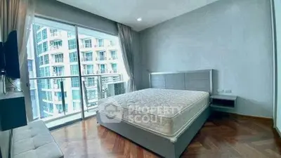 Spacious bedroom with large windows and balcony in modern apartment