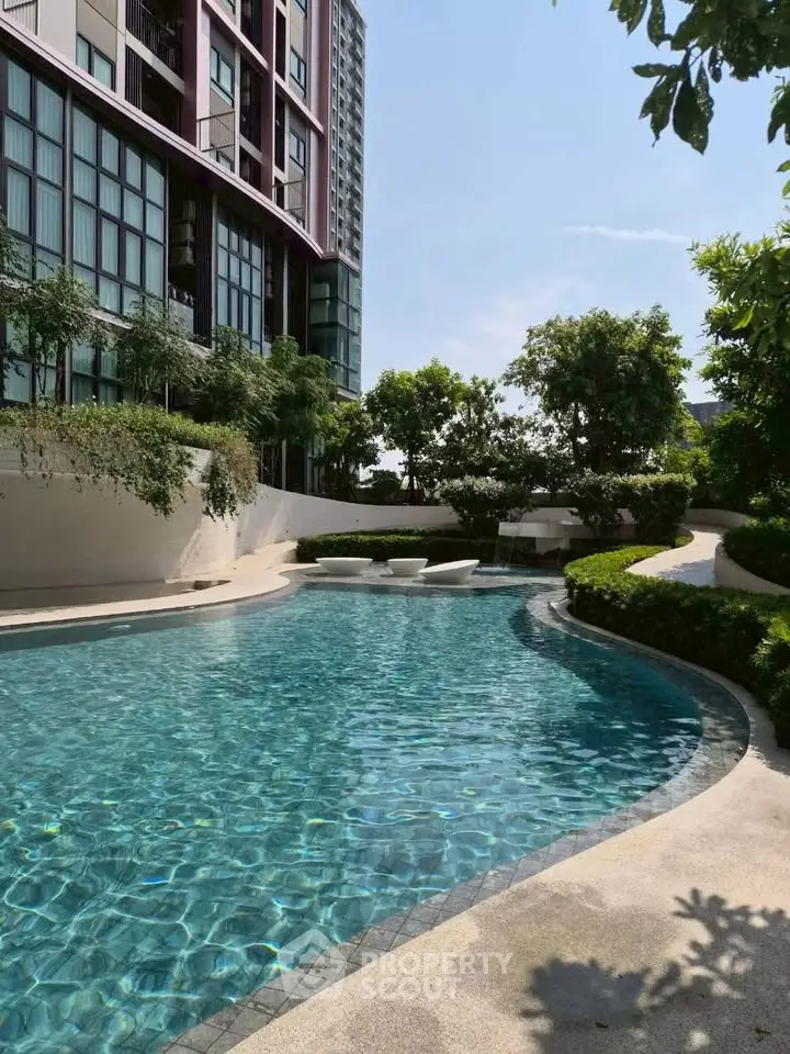 Luxurious residential building with serene outdoor pool and lush greenery.