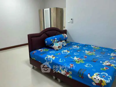 Spacious bedroom with modern bed and wardrobe, perfect for comfort and style.