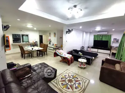 Spacious living room with modern furniture and open layout, perfect for family gatherings.