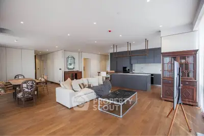 Spacious modern living room with open kitchen and elegant furnishings