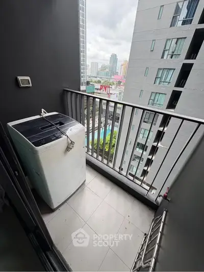 Modern apartment balcony with washing machine and city view