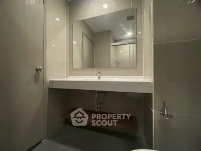 Modern bathroom with sleek design and large mirror in a contemporary home.