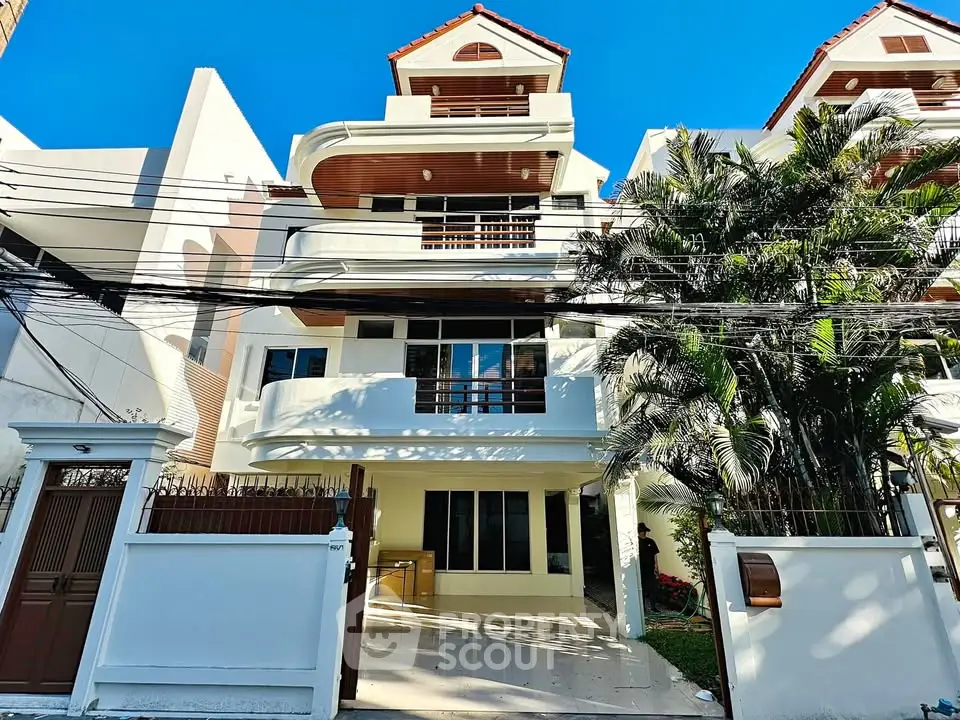 Stunning multi-story residential building with modern architecture and lush greenery.