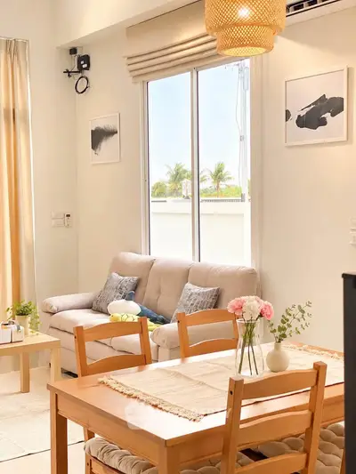 Bright and cozy living room with modern decor and large window view.