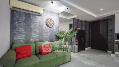 Modern living room with green sofa, stylish decor, and air conditioning