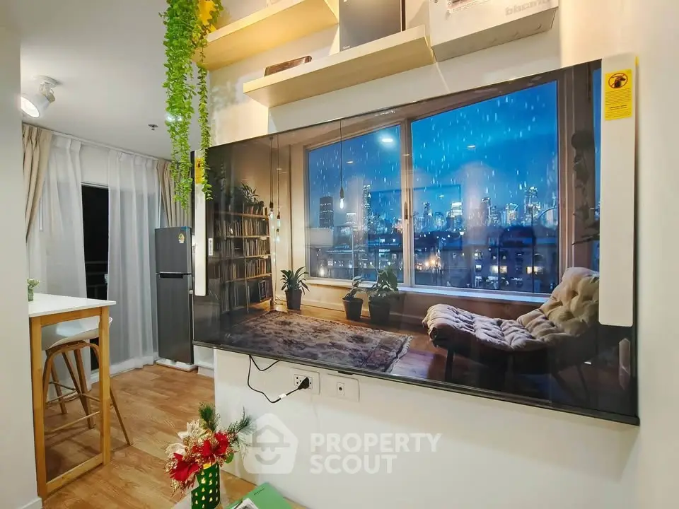 Modern living room with large TV, cozy decor, and city view, perfect for urban living.