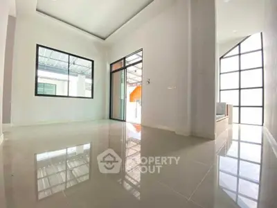 Spacious modern interior with large windows and glossy tiled floors