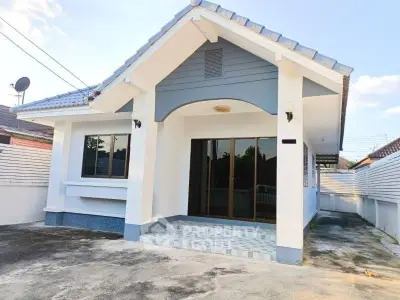 Charming single-story house with modern design and spacious driveway, perfect for family living.