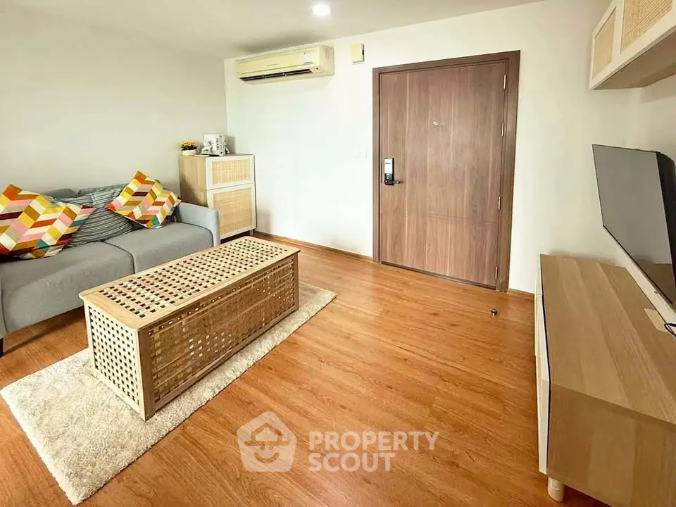 Modern living room with wooden flooring, stylish furniture, and cozy ambiance.