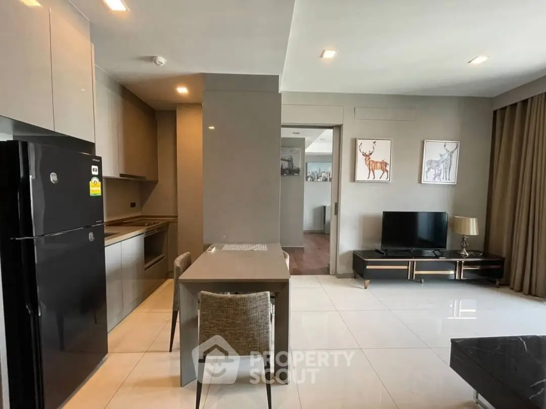 Modern open-plan kitchen and living room with sleek design and stylish decor.