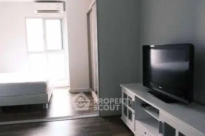 Modern bedroom with sleek TV setup and minimalist decor