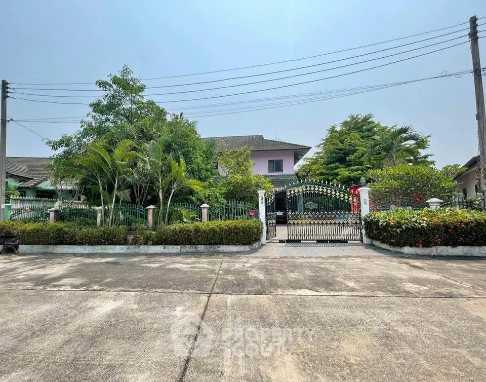 Charming suburban house with lush garden and gated entrance, perfect for family living.