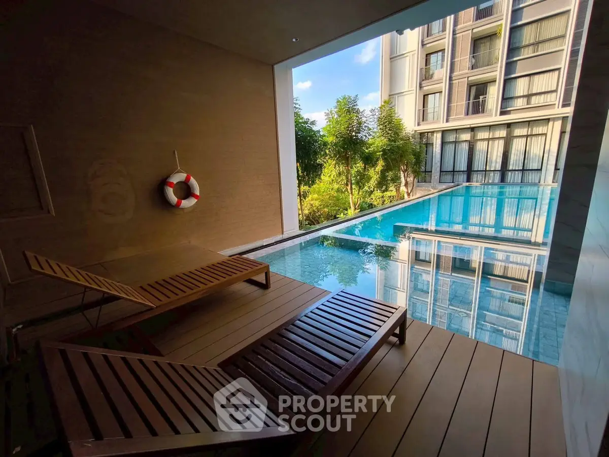 Luxurious poolside view with modern architecture and lush greenery