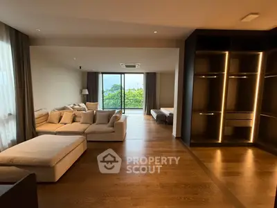 Spacious modern living room with large windows and cozy seating area