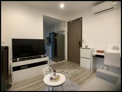 Modern living room with sleek furniture and open kitchen layout