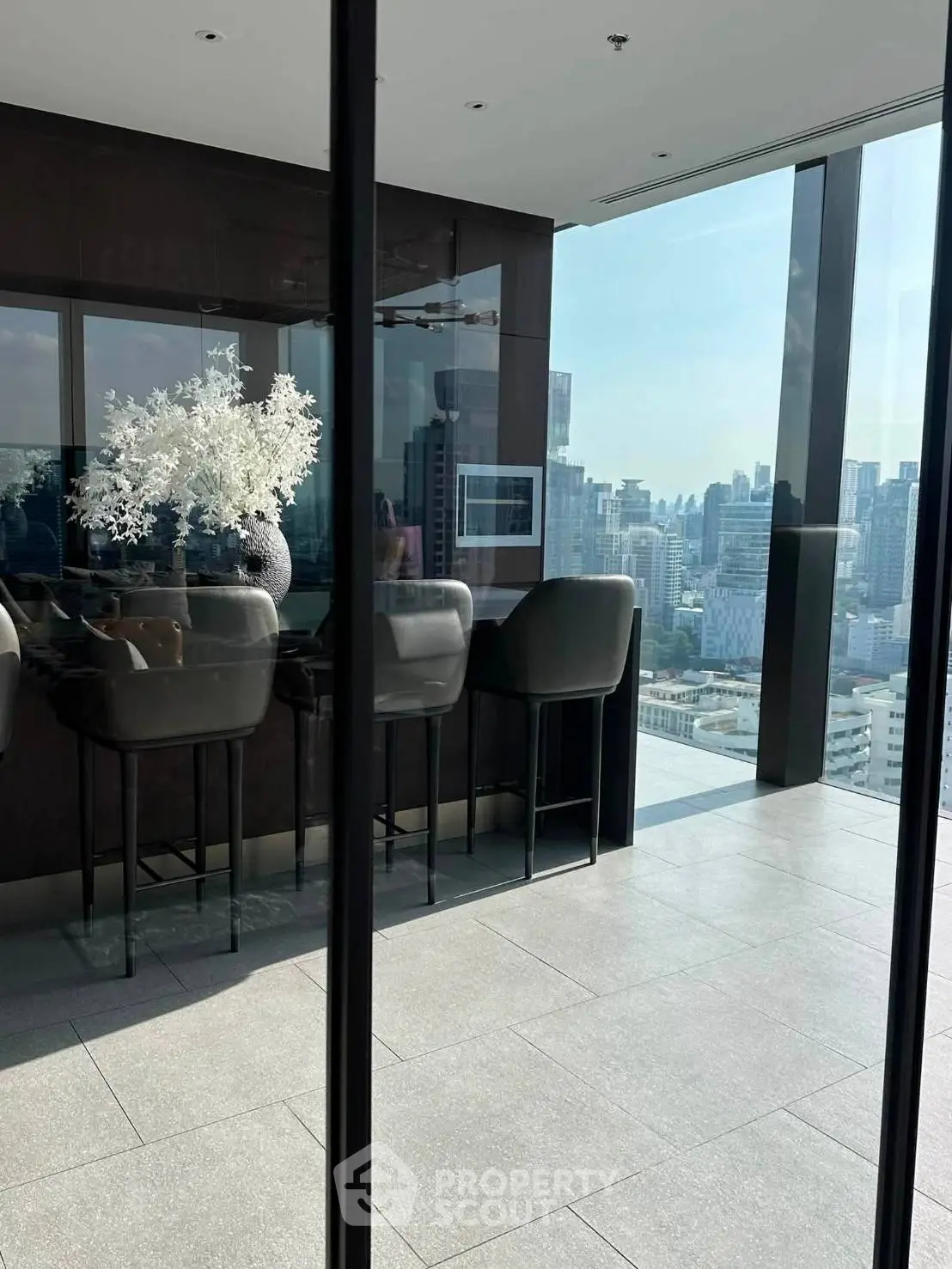 Luxurious high-rise apartment with stunning city view and elegant interior design.