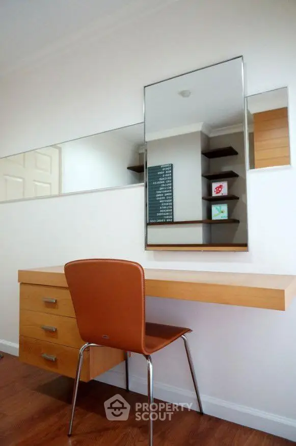 Modern study area with sleek wooden desk and stylish chair, perfect for productivity.