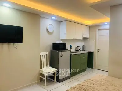Cozy studio apartment with modern kitchenette and ambient lighting