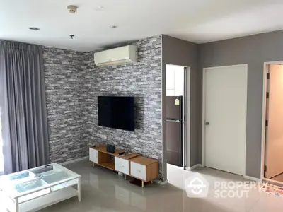 Modern living room with brick accent wall, air conditioning, and sleek furniture