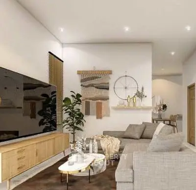 Modern living room with stylish decor and large TV, featuring cozy seating and elegant lighting.