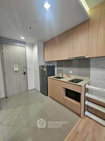 Modern kitchen with sleek cabinetry and built-in appliances in a compact layout.