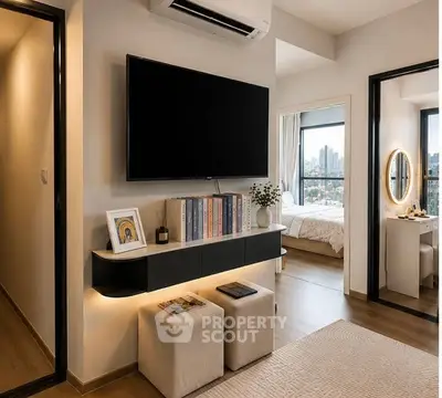 Modern living room with wall-mounted TV and view into stylish bedroom.