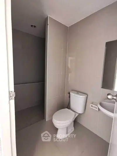 Modern bathroom with sleek fixtures and neutral tiles, perfect for a minimalist home design.