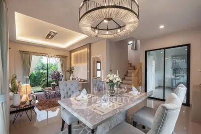 Luxurious open-plan living and dining area with elegant decor and garden view.