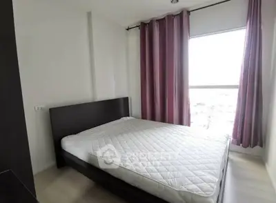 Modern bedroom with large window and stylish curtains in a bright apartment.