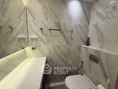 Luxurious marble bathroom with modern fixtures and ambient lighting